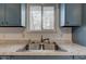 Kitchen sink featuring modern faucet, speckled countertops, and natural light at 4018 S State Road 75, Coatesville, IN 46121