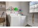 Laundry area features washing machine and dryer set next to back door at 4018 S State Road 75, Coatesville, IN 46121