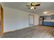 Open living room with hardwood floors, ceiling fan, and view to the kitchen at 4018 S State Road 75, Coatesville, IN 46121