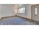 Bright living room with neutral carpet, white walls and a large window providing ample natural light at 4018 S State Road 75, Coatesville, IN 46121
