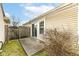 A small concrete backyard with a privacy fence, sliding glass door, and lawn at 5142 Pin Oak Dr, Indianapolis, IN 46254