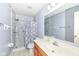 Clean bathroom featuring a shower with marbled walls and a sink with a wood cabinet at 5142 Pin Oak Dr, Indianapolis, IN 46254