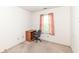 Small bedroom with a desk and chair next to a window with pink floral curtains at 5142 Pin Oak Dr, Indianapolis, IN 46254