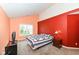 Bright bedroom with a window and colorful walls; features a comfortable bed and nightstand at 5142 Pin Oak Dr, Indianapolis, IN 46254