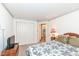 Bedroom with a decorative wallpaper trim, bed, closet and neutral carpet at 5142 Pin Oak Dr, Indianapolis, IN 46254