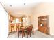 Inviting dining area next to the breakfast bar with great natural light and an adjacent display cabinet at 5142 Pin Oak Dr, Indianapolis, IN 46254