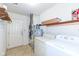 Functional laundry area features shelving, and a washer and dryer set at 5142 Pin Oak Dr, Indianapolis, IN 46254