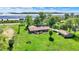 Aerial view of a home on a large lot with mature trees and a detached garage at 5272 N Graham Rd, Whiteland, IN 46184