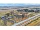 Aerial view showcases sprawling properties surrounded by fields and distant buildings at 5272 N Graham Rd, Whiteland, IN 46184