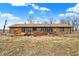 Backyard view of house featuring a stone facade and wooden deck at 5272 N Graham Rd, Whiteland, IN 46184
