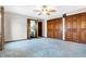 Bedroom featuring carpet, a ceiling fan, light walls, and double closets at 5272 N Graham Rd, Whiteland, IN 46184