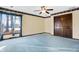 Inviting bedroom with natural light, blue carpeting, and ample closet space for storage at 5272 N Graham Rd, Whiteland, IN 46184