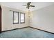 Bedroom featuring two windows with blinds, and light blue carpet flooring at 5272 N Graham Rd, Whiteland, IN 46184