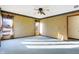 Bright bedroom featuring a large window with sheer curtains and comfortable blue carpeting at 5272 N Graham Rd, Whiteland, IN 46184