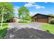 Long driveway and two-car garage, with an extra storage shed, provide ample parking at 5272 N Graham Rd, Whiteland, IN 46184