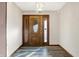 Inviting entryway featuring a wooden door with glass panes and modern flooring at 5272 N Graham Rd, Whiteland, IN 46184