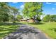 Lush front lawn and long driveway lead up to this charming home with stone facade at 5272 N Graham Rd, Whiteland, IN 46184