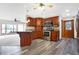 Bright kitchen with stainless steel appliances, breakfast bar and hardwood floors at 5272 N Graham Rd, Whiteland, IN 46184
