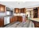 Well-lit kitchen with stainless steel dishwasher, granite countertops, and wood cabinets at 5272 N Graham Rd, Whiteland, IN 46184
