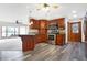 Open-concept kitchen featuring wood cabinets, a stone countertop breakfast bar, and stainless steel appliances at 5272 N Graham Rd, Whiteland, IN 46184