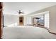 Open living room featuring a large carpeted area, a ceiling fan, and a large bay window at 5272 N Graham Rd, Whiteland, IN 46184