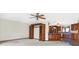Open-concept living room adjacent to kitchen with hardwood floors and custom wood built-ins at 5272 N Graham Rd, Whiteland, IN 46184