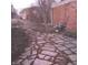 Backyard featuring a stone pathway, mature trees, and a bird bath at 5506 N Drexel Ave, Indianapolis, IN 46220