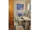 Charming bathroom featuring a unique glass block window and pedestal sink at 5506 N Drexel Ave, Indianapolis, IN 46220