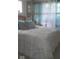 Comfortable bedroom with a white bedspread, plush pillows, and sheer curtains allowing natural light to filter in at 5506 N Drexel Ave, Indianapolis, IN 46220