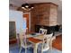 Inviting dining area with a wooden table set for four, complemented by a stone fireplace at 5506 N Drexel Ave, Indianapolis, IN 46220