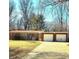 Charming ranch-style home featuring a brick facade and two-car garage, set on a spacious lot with mature trees at 5506 N Drexel Ave, Indianapolis, IN 46220