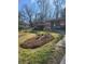 Well-maintained front yard with fresh landscaping, a blooming garden, and a welcoming entrance at 5506 N Drexel Ave, Indianapolis, IN 46220