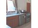 Modern kitchen with stainless steel appliances, light wood cabinets, and a sink with a window view at 5506 N Drexel Ave, Indianapolis, IN 46220