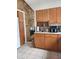 Cozy kitchen featuring wooden cabinets, tile flooring, and countertop appliances at 5506 N Drexel Ave, Indianapolis, IN 46220