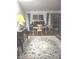 Bright living room featuring hardwood floors, large windows with curtains, and a cozy desk setup at 5506 N Drexel Ave, Indianapolis, IN 46220