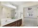 Bathroom with double vanity and an open view into the bedroom at 660 Overcup St, Westfield, IN 46074