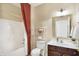 Cozy bathroom featuring a shower with curtain, storage shelves, vanity, and mirror at 660 Overcup St, Westfield, IN 46074