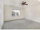 Bright bedroom showcasing a large window, neutral walls, and plush carpeting at 660 Overcup St, Westfield, IN 46074