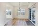 Bright dining room features wood floors, pendant lighting, a large window, and sliding glass door at 660 Overcup St, Westfield, IN 46074