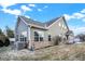 Rear view of house with vinyl siding and brick foundation, yard with partial snow at 660 Overcup St, Westfield, IN 46074