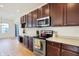 Modern kitchen showcasing stainless steel appliances, hardwood floors, and ample counter space at 660 Overcup St, Westfield, IN 46074