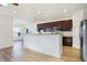 Spacious kitchen featuring hardwood floors, modern appliances, and an open connection to the dining area at 660 Overcup St, Westfield, IN 46074