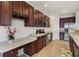 Charming kitchen with hardwood floors, stainless steel appliances, and stylish dark wood cabinetry at 660 Overcup St, Westfield, IN 46074