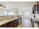 Bright kitchen with hardwood floors, stainless steel appliances, and a view into the adjacent living spaces at 660 Overcup St, Westfield, IN 46074