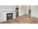 Living area showcasing hardwood flooring and cozy fireplace with views of the staircase at 660 Overcup St, Westfield, IN 46074