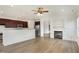 Open concept living room featuring hardwood floors, a fireplace, and seamless flow into the kitchen at 660 Overcup St, Westfield, IN 46074