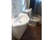 Compact bathroom with a white sink and toilet in front of a window, showcasing essential facilities at 732 W 12Th St, Indianapolis, IN 46202