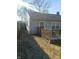 View of the side of a house with a wooden fence and deck under a sunny sky, creating a welcoming outdoor space at 732 W 12Th St, Indianapolis, IN 46202