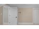 Unfinished basement featuring neutral color palette, bare carpet and an open door at 7999 Englewood Rd, Indianapolis, IN 46240