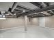 Finished basement with open concept, gray painted ceiling joists and white floors at 7999 Englewood Rd, Indianapolis, IN 46240